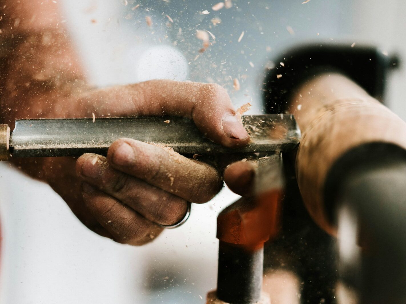 person holding silver and orange pipe