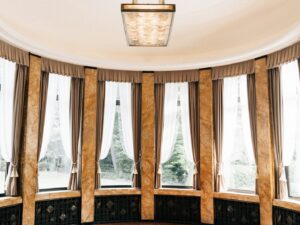 Elegant room with large windows and ornate columns